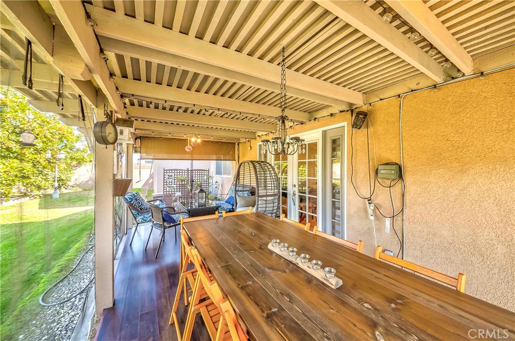 5431 Marion Avenue Cypress, CA 90630 - Photo 20 of 22 a view of a patio with table and chairs a barbeque with wooden floor and fence