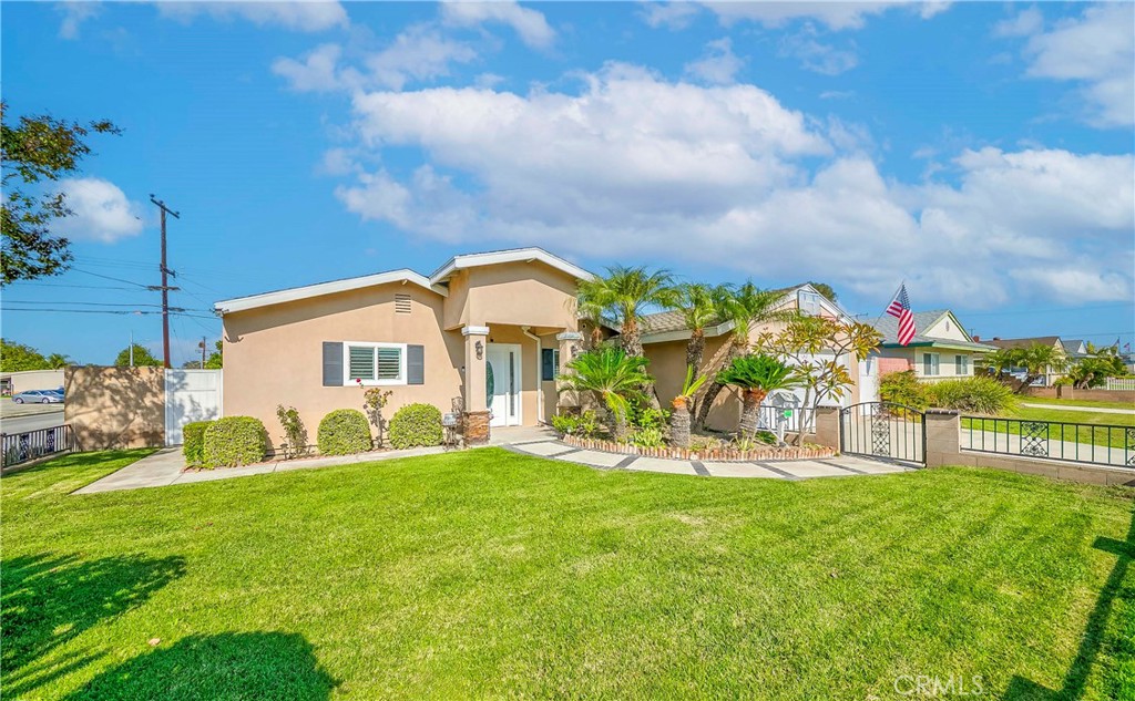 5431 Marion Avenue Cypress, CA 90630 - Photo 2 of 22 a view of a house with a big yard and potted plants