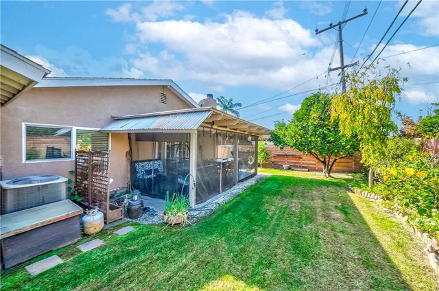 a view of a house with a yard and sitting area