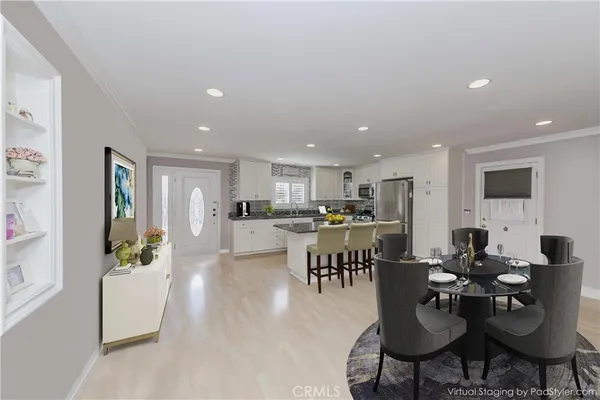 a living room with lots of furniture kitchen view and a dining table