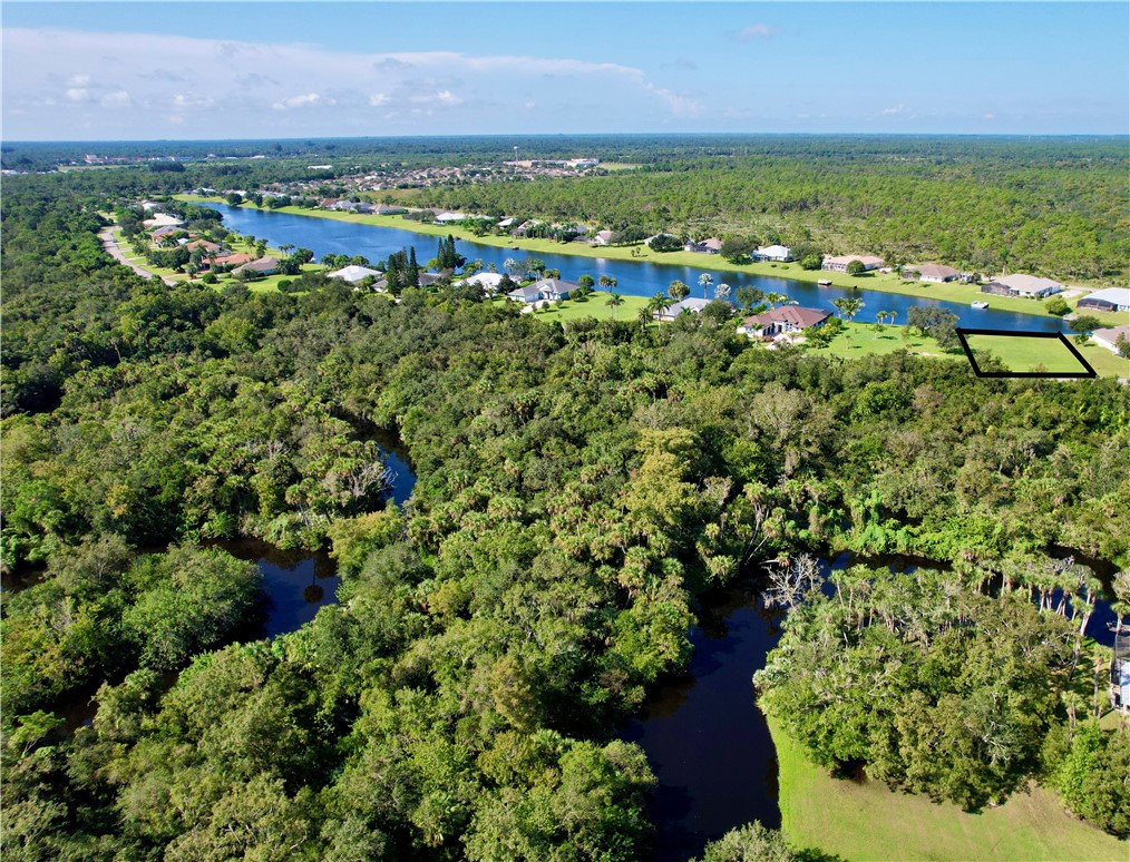 1552 Eagles Circle Sebastian, FL 32958 - Photo 9 of 16 an aerial view of residential houses with outdoor space and trees