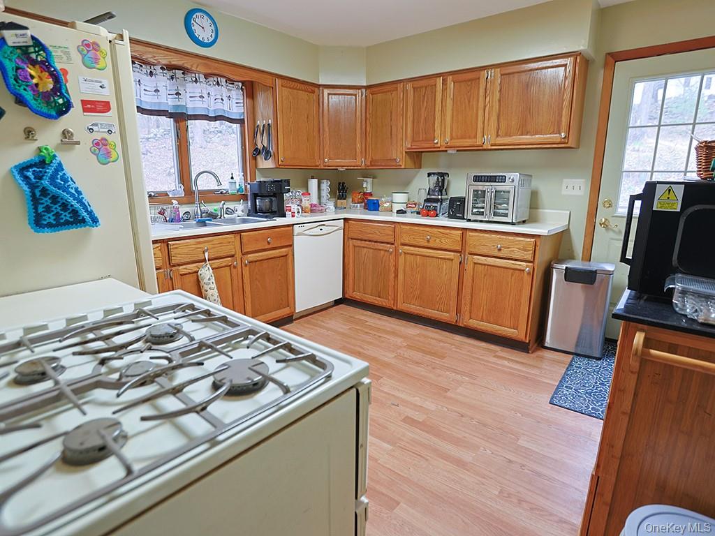 68 Kennel Road Cuddebackville, NY 12729 - Photo 12 of 21 a kitchen with stainless steel appliances granite countertop a stove a sink dishwasher and a refrigerator with wooden floor