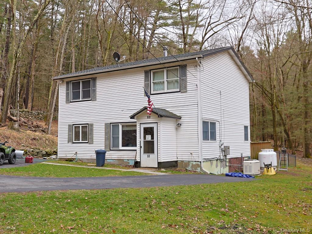 68 Kennel Road Cuddebackville, NY 12729 - Photo 2 of 21 a front view of a house with a yard