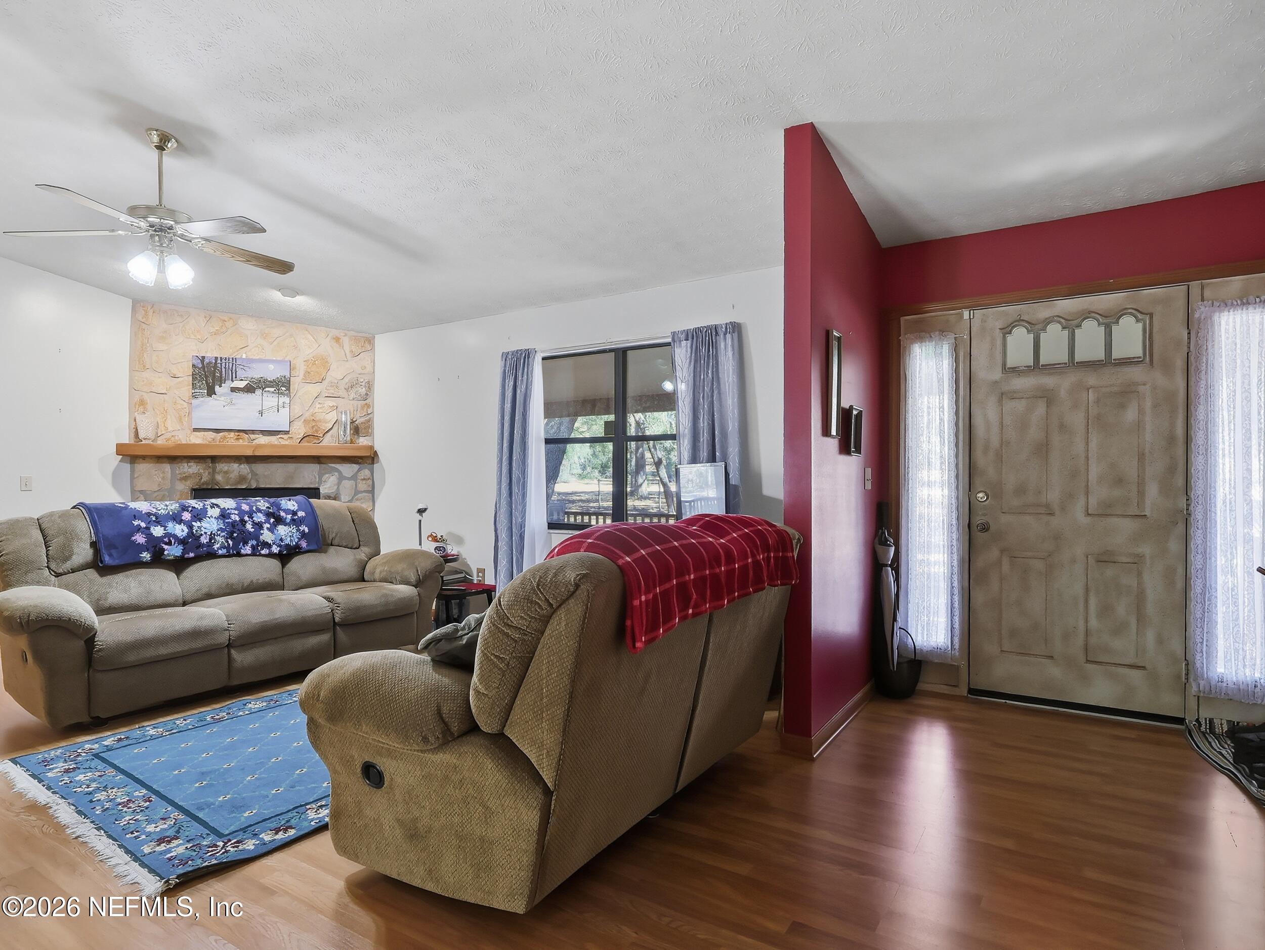 8336 Singleton Place Keystone Heights, FL 32656 - Photo 14 of 56 a living room with a bed furniture and a window