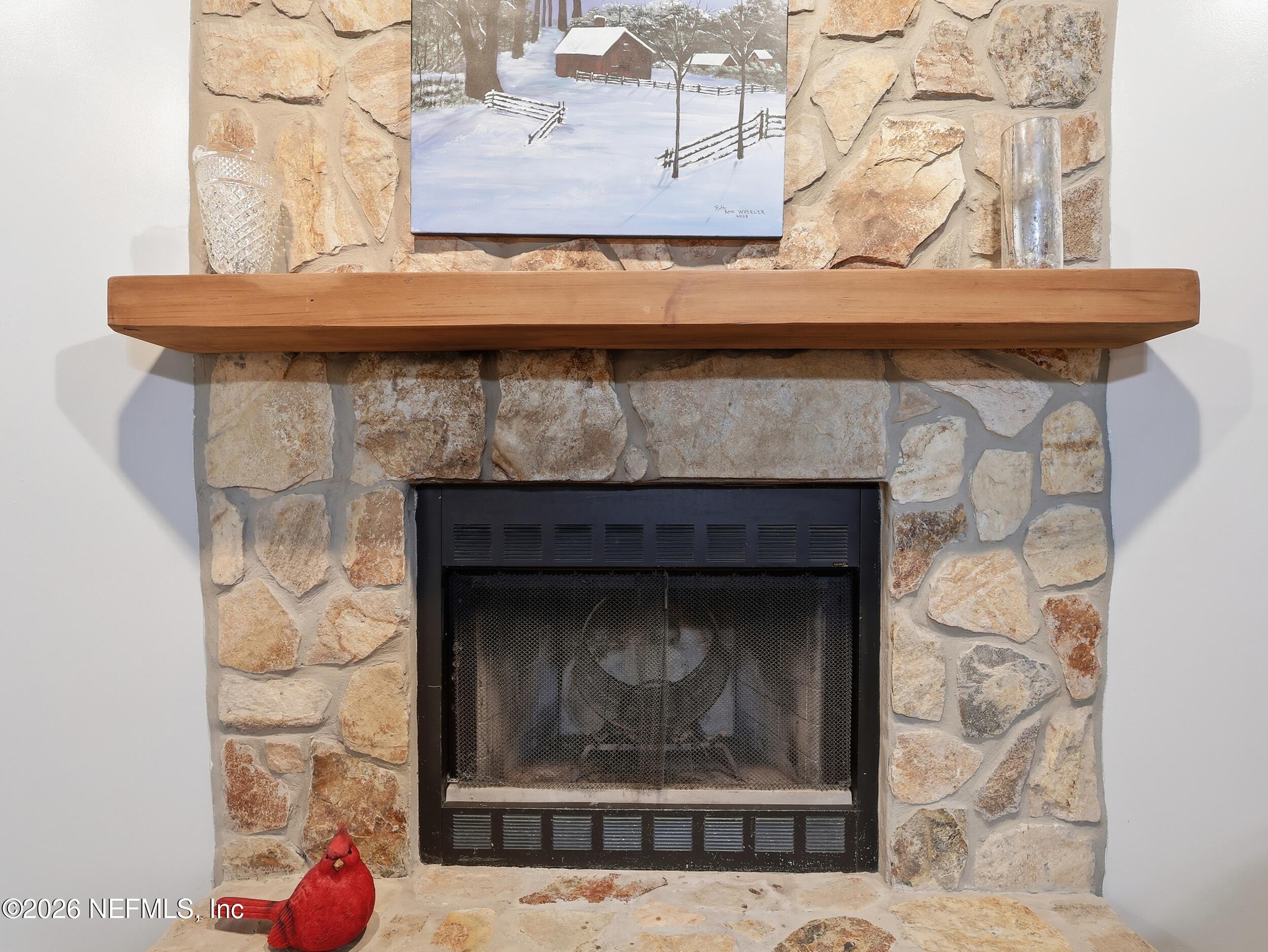 8336 Singleton Place Keystone Heights, FL 32656 - Photo 16 of 56 a fireplace with a clock on it