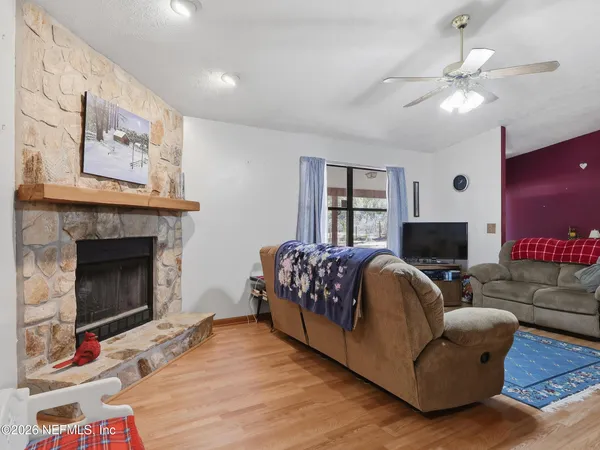 a kitchen with granite countertop cabinets a stove and a wooden floor