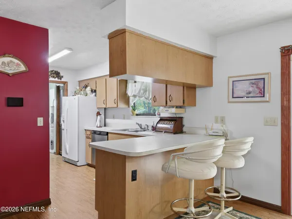 a room with wooden floor table and chairs