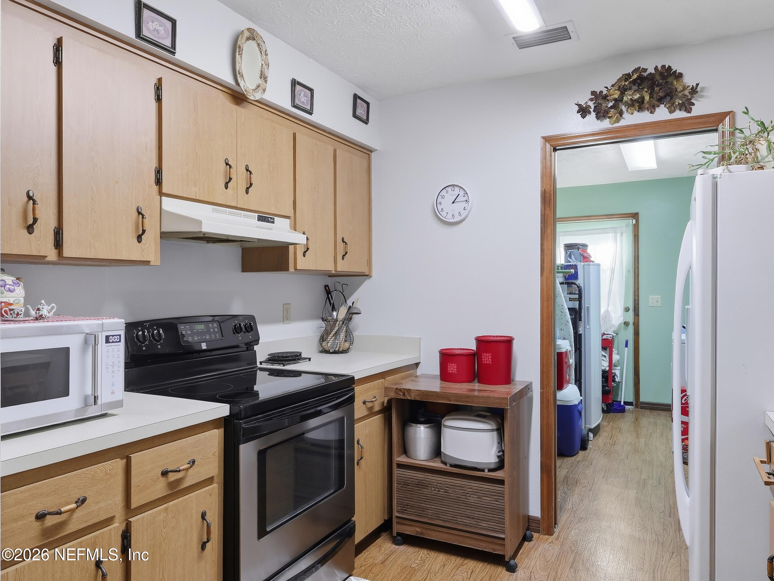 8336 Singleton Place Keystone Heights, FL 32656 - Photo 20 of 56 a kitchen with stainless steel appliances granite countertop a stove and a microwave