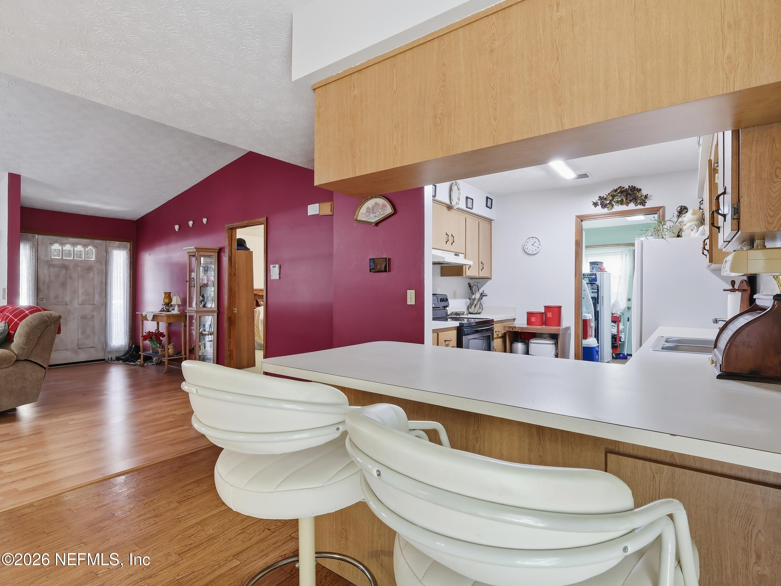 8336 Singleton Place Keystone Heights, FL 32656 - Photo 22 of 56 a room with wooden floor table and chairs