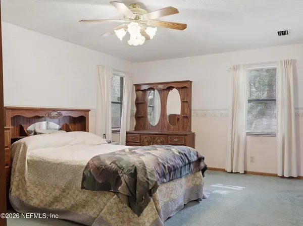 a bedroom with a bed and a table