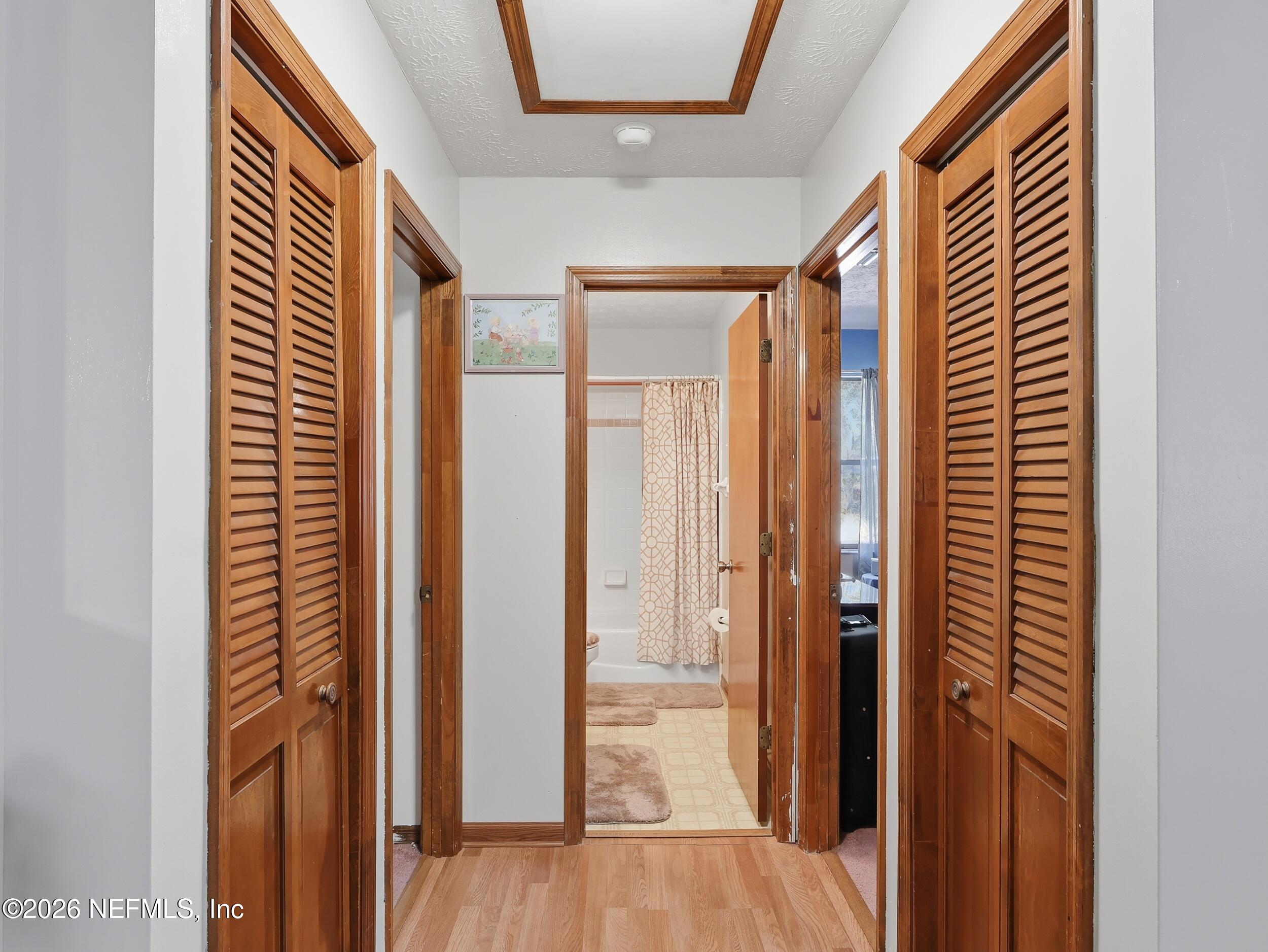 8336 Singleton Place Keystone Heights, FL 32656 - Photo 31 of 56 a view of a hallway with wooden floor and staircase