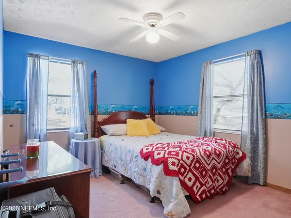 a view of a house with a tree in the yard