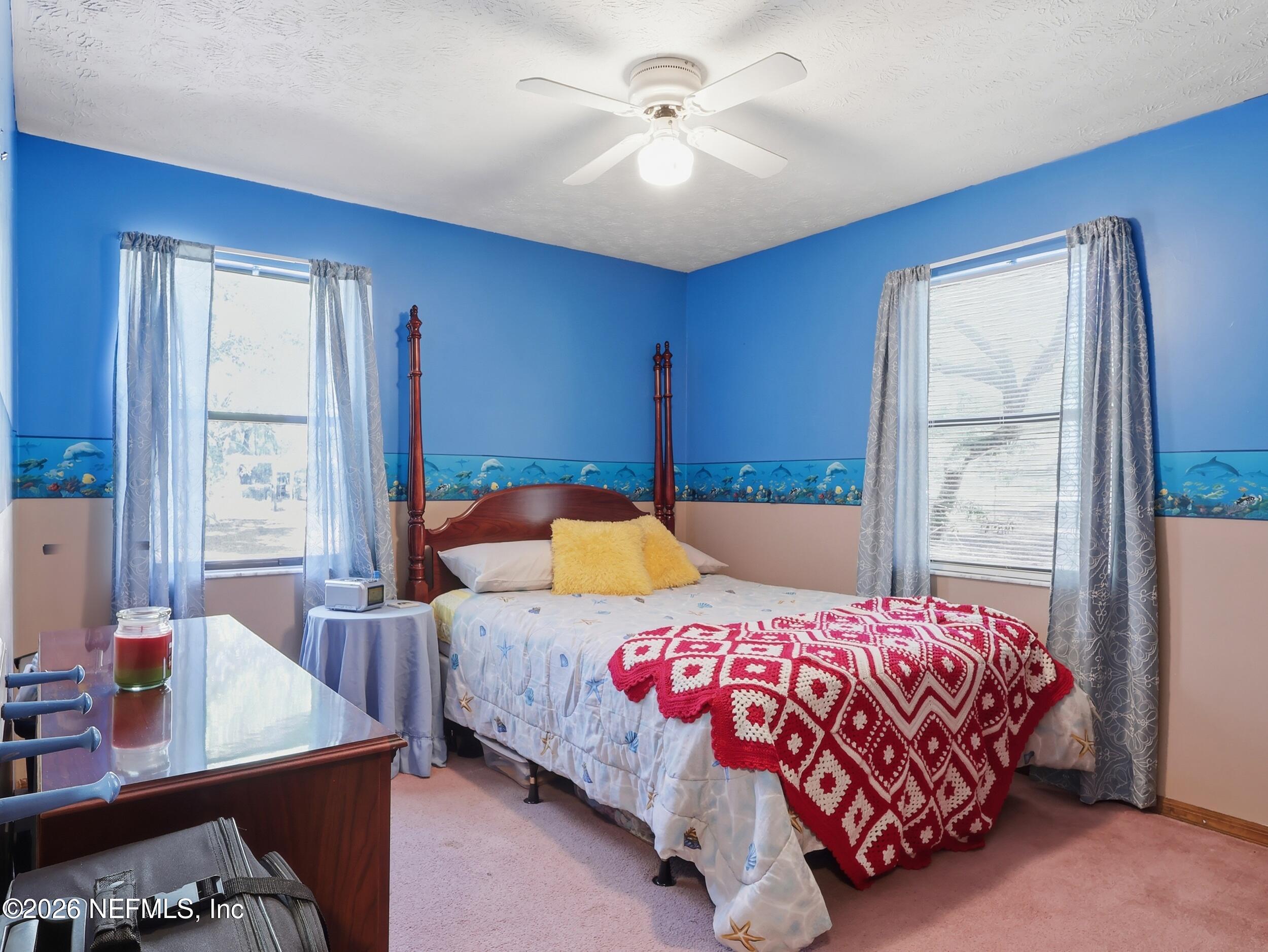 8336 Singleton Place Keystone Heights, FL 32656 - Photo 32 of 56 a bedroom with a bed and a table