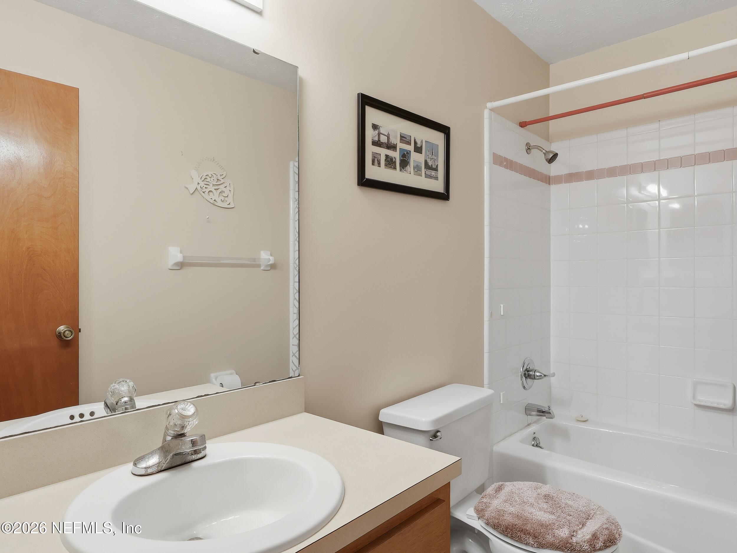 8336 Singleton Place Keystone Heights, FL 32656 - Photo 33 of 56 a bathroom with a sink and a mirror