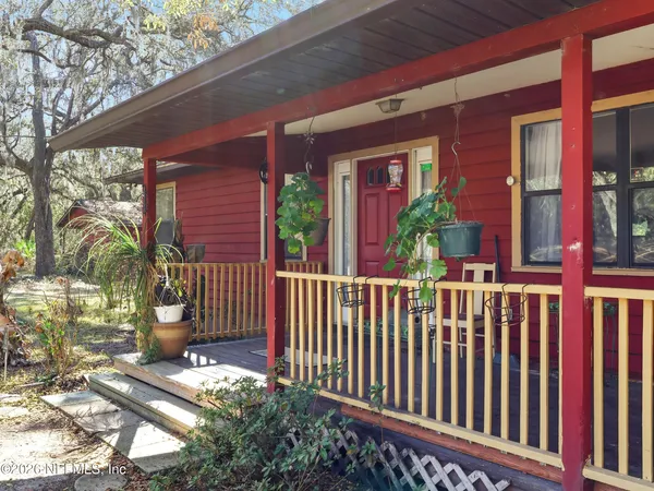 a view of a yard with wooden fence