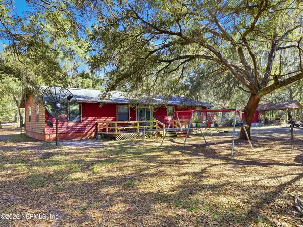 a backyard of a house with a tree