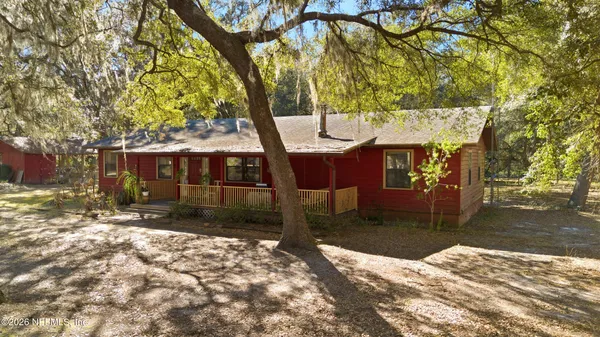 a view of a balcony with furniture and wooden floor