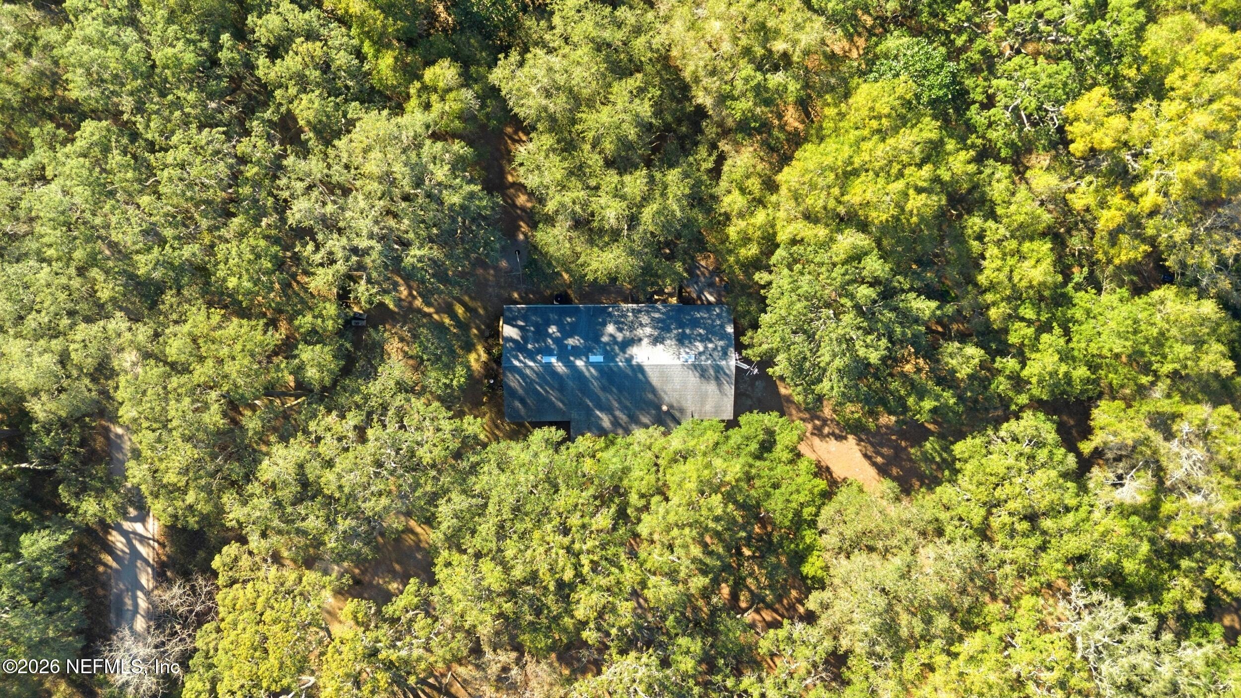 8336 Singleton Place Keystone Heights, FL 32656 - Photo 55 of 56 a backyard of a house with a tree