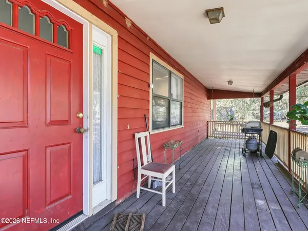 a view of a porch with furniture and wooden floor