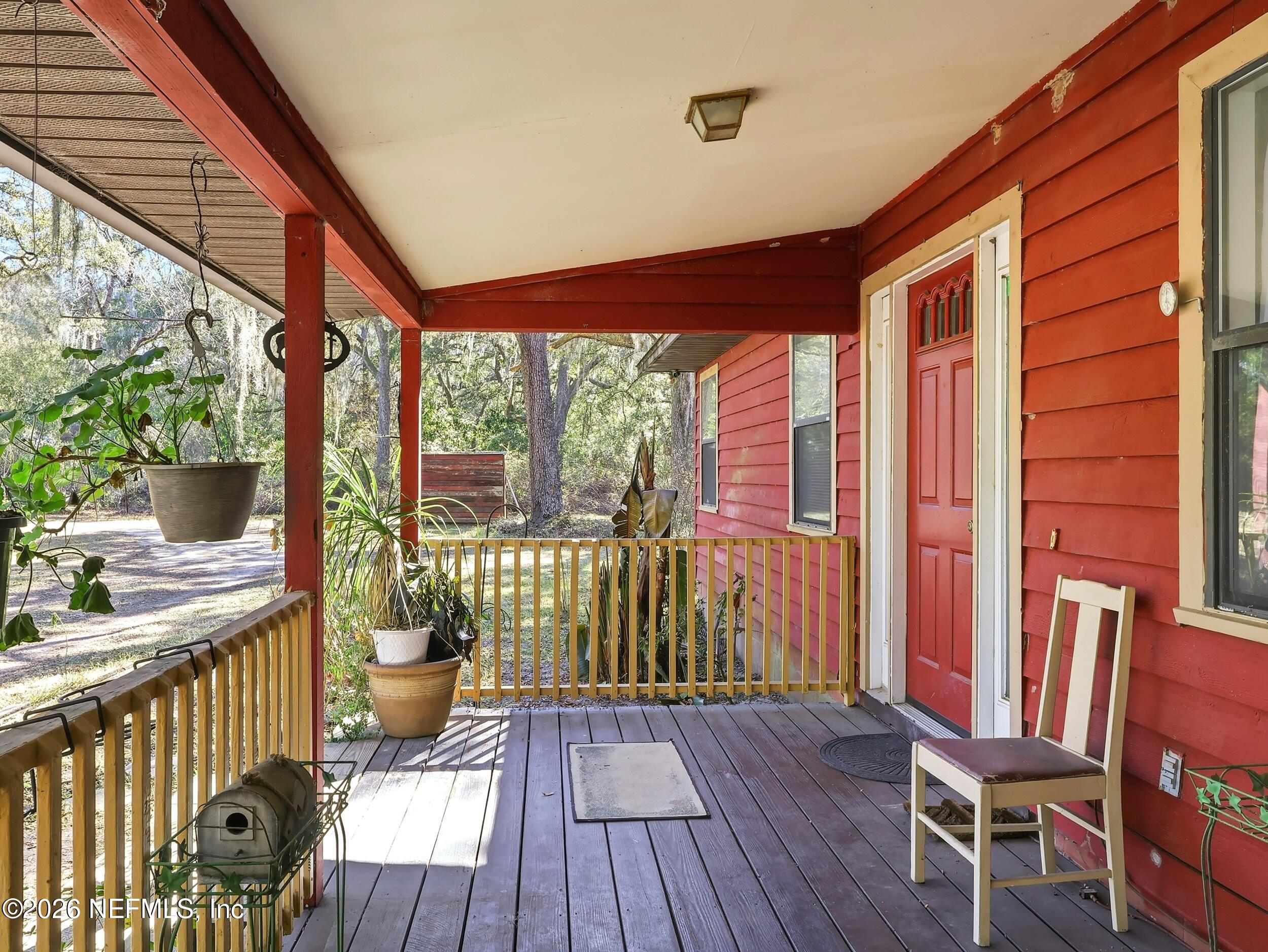 8336 Singleton Place Keystone Heights, FL 32656 - Photo 10 of 56 a view of a porch with furniture and wooden floor
