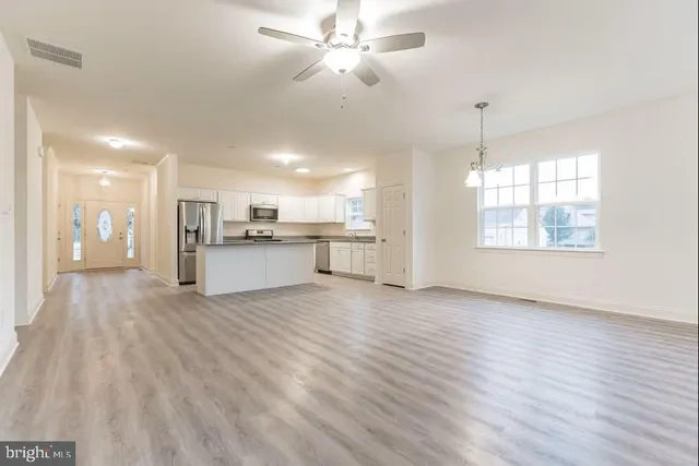 a view of a kitchen with an empty space and a window