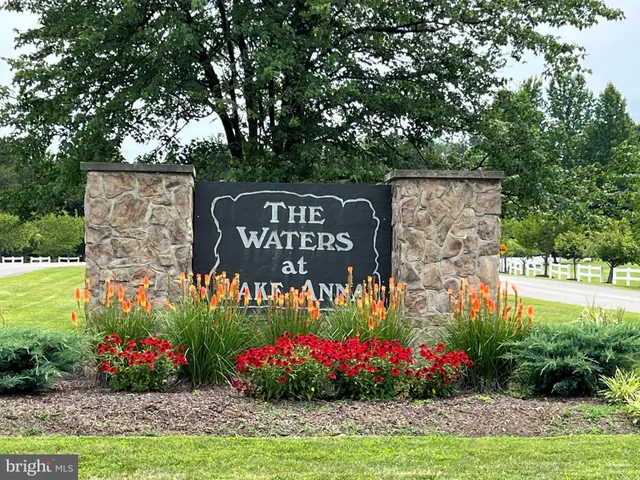 a view of sign board in front of flowers