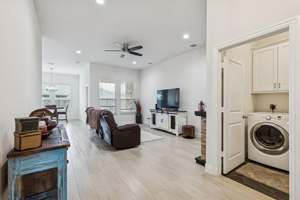 388 Montague Street Pilot Point, TX 76258 - Photo 4 of 28 a living room with furniture a flat screen tv and a fireplace