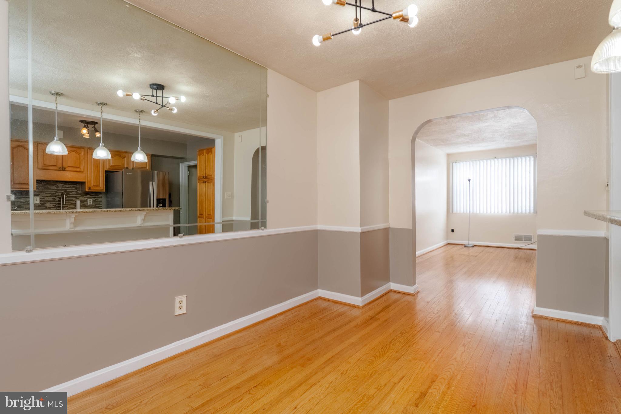 5413 Channing Road Baltimore, MD 21229 - Photo 12 of 45 wooden floor in an empty room with a window