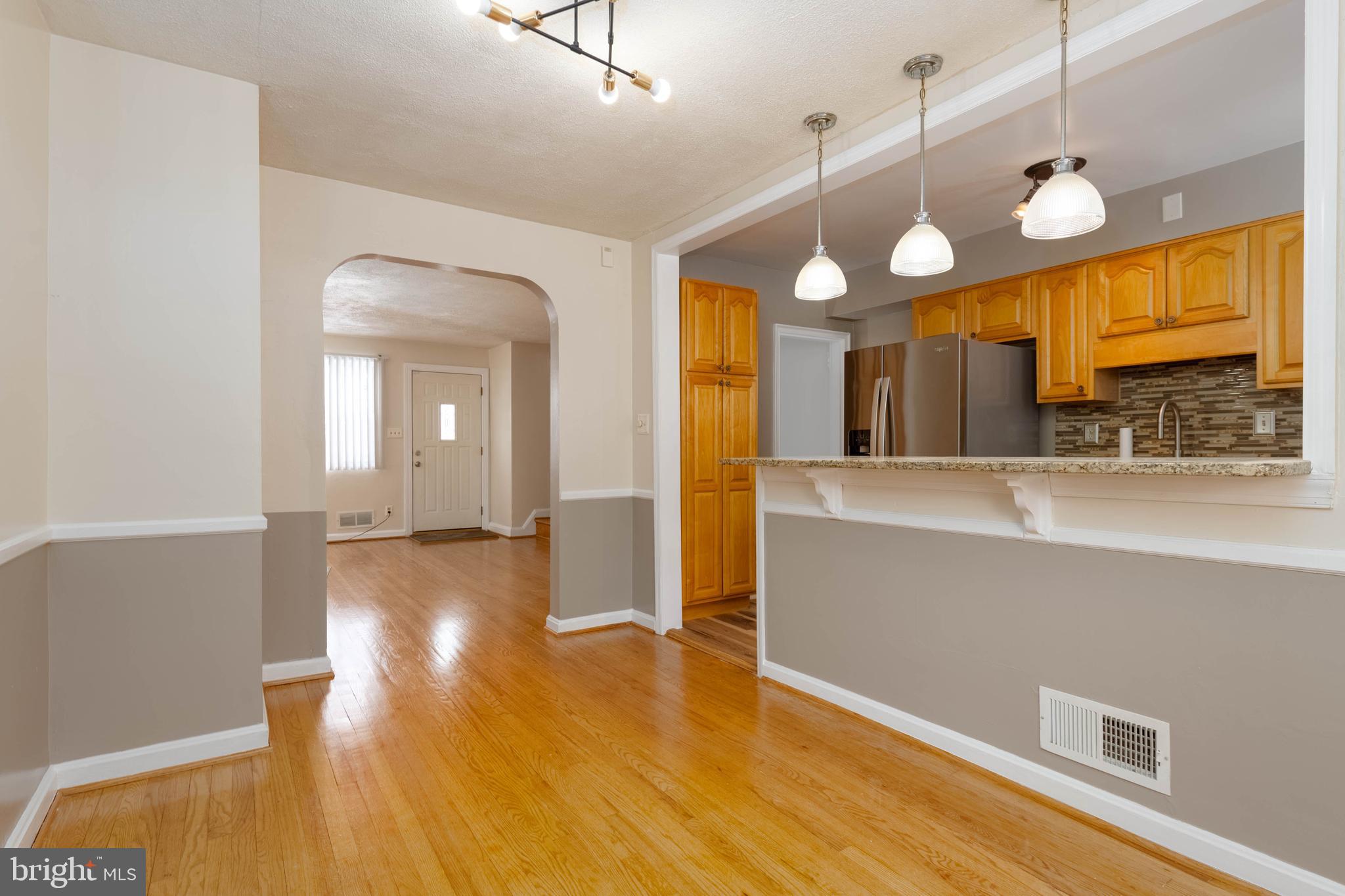 5413 Channing Road Baltimore, MD 21229 - Photo 13 of 45 a view of a kitchen and a chandelier fan