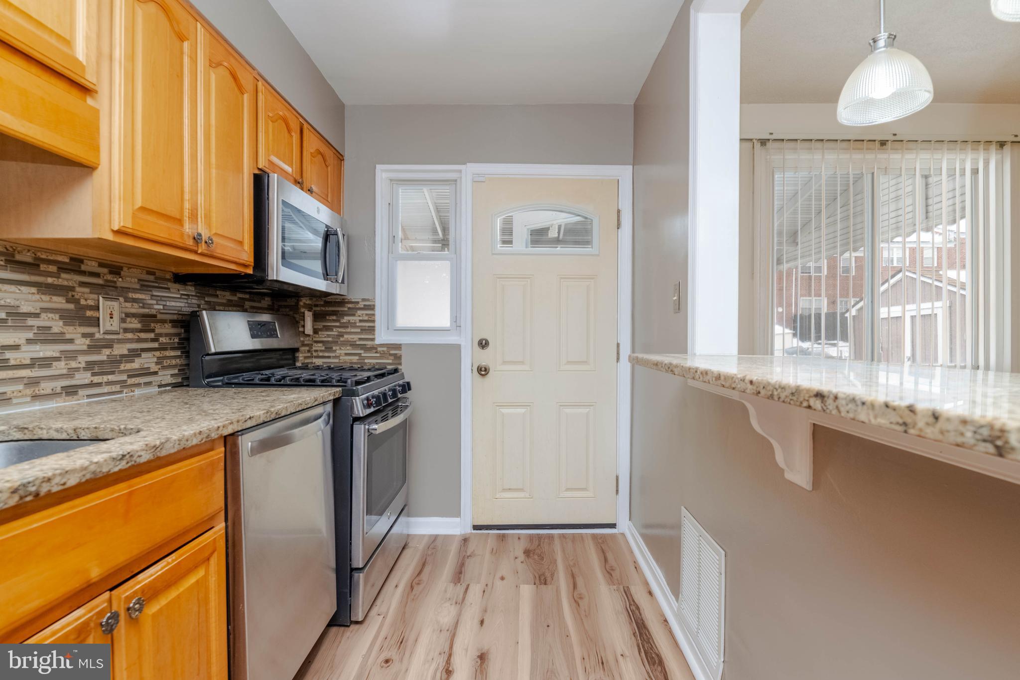 5413 Channing Road Baltimore, MD 21229 - Photo 14 of 45 a kitchen with a sink a counter top space cabinets and stainless steel appliances