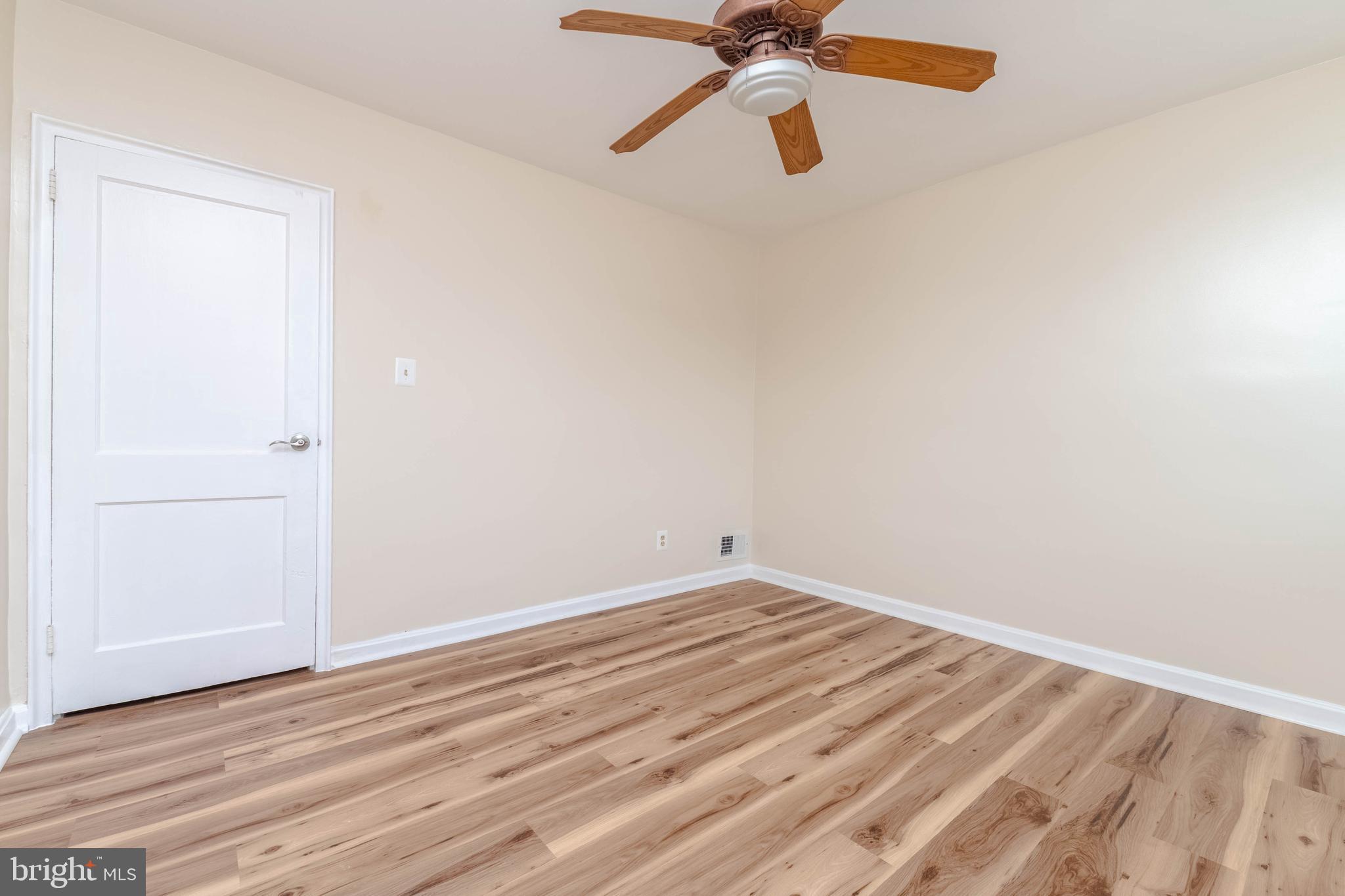 5413 Channing Road Baltimore, MD 21229 - Photo 27 of 45 an empty room with wooden floor closet and fan