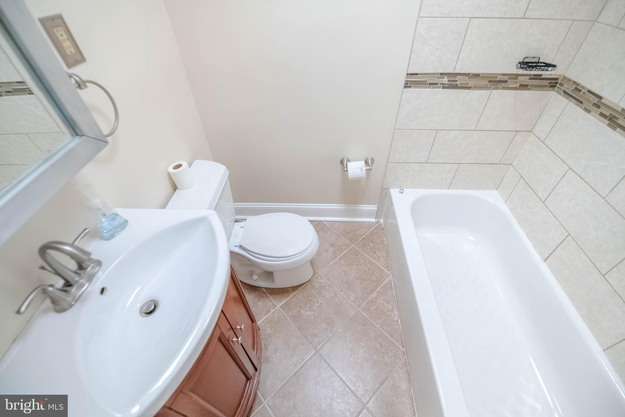 5413 Channing Road Baltimore, MD 21229 - Photo 29 of 45 a bathroom with a sink and toilet
