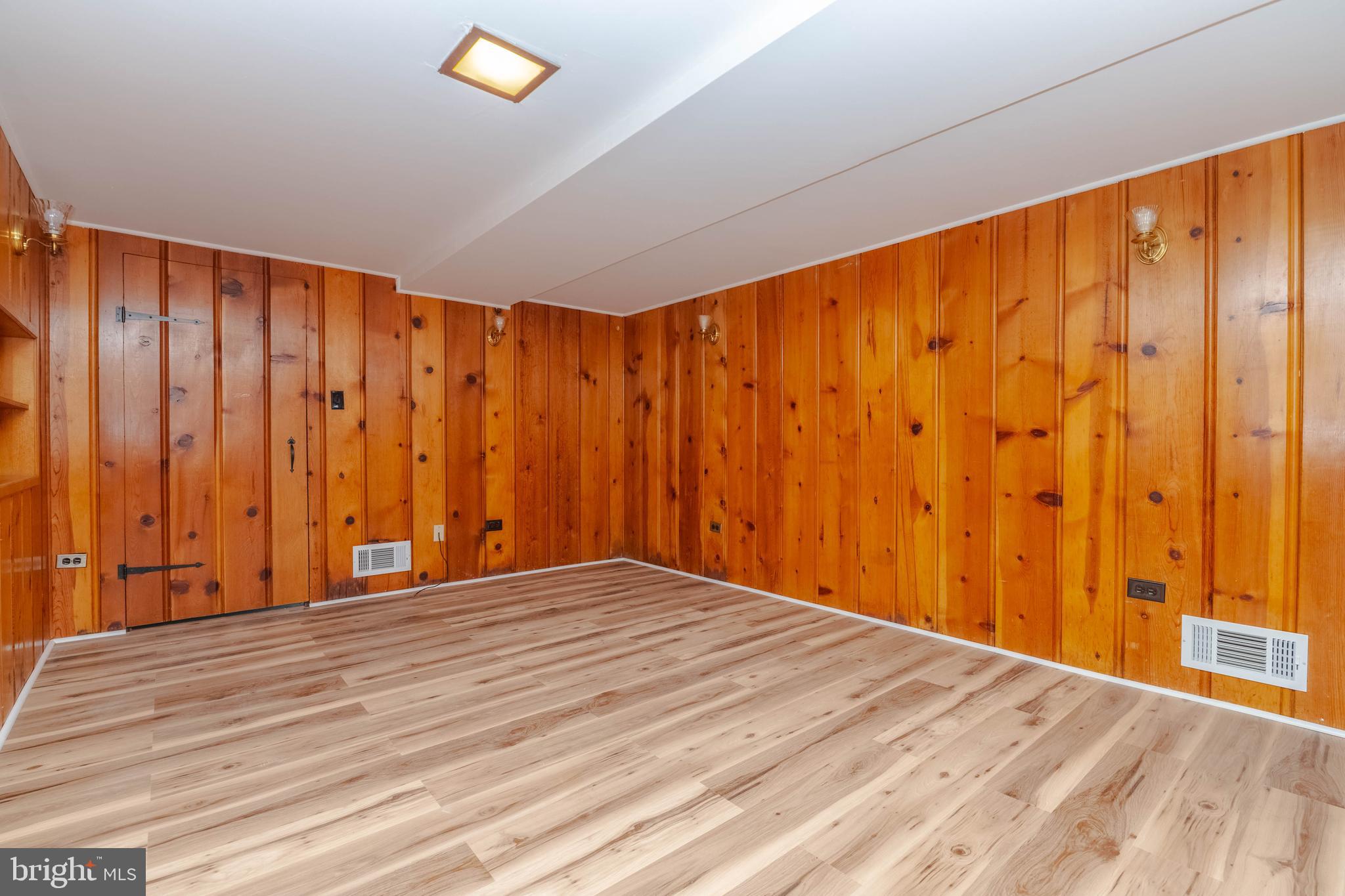 5413 Channing Road Baltimore, MD 21229 - Photo 33 of 45 a view of an empty room with a window and wooden floor