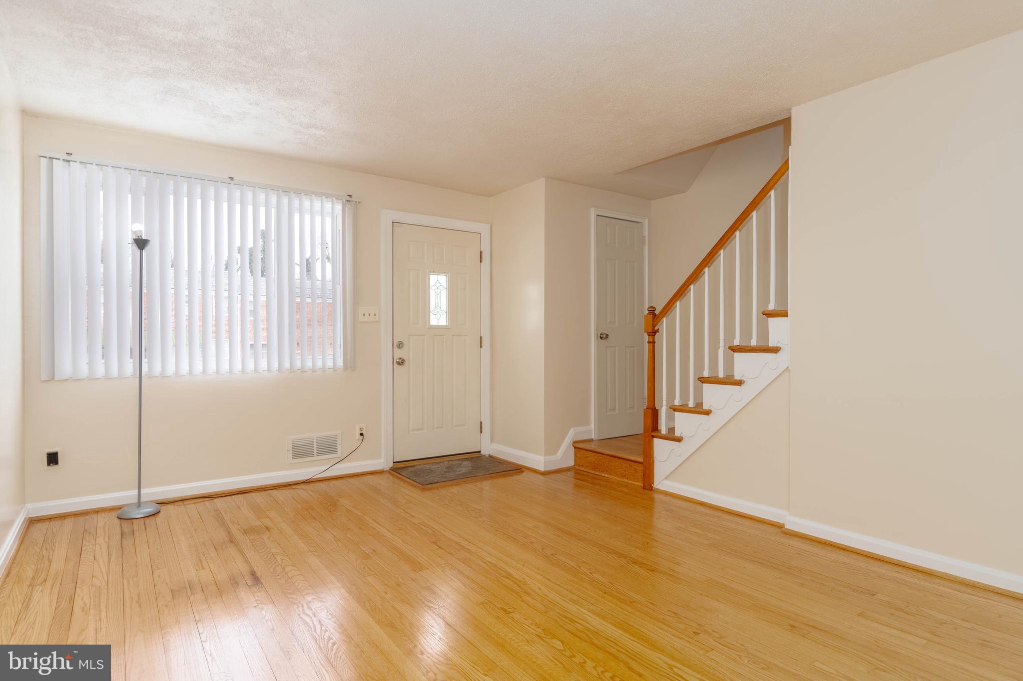 5413 Channing Road Baltimore, MD 21229 - Photo 6 of 45 a view of an empty room with wooden floor and a window