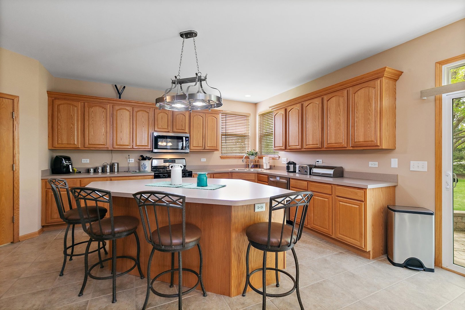 244 Prescott Avenue Elgin, IL 60124 - Photo 10 of 31 a kitchen with stainless steel appliances a table and chairs in it