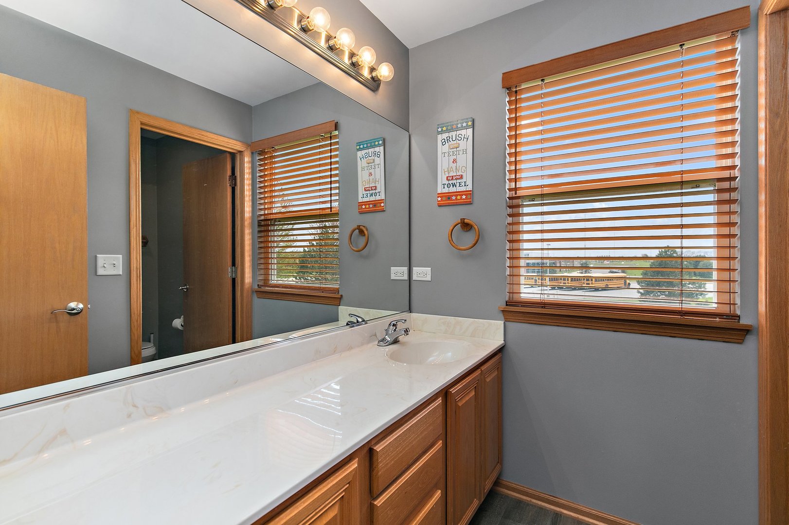 244 Prescott Avenue Elgin, IL 60124 - Photo 22 of 31 a bathroom with a sink and a mirror