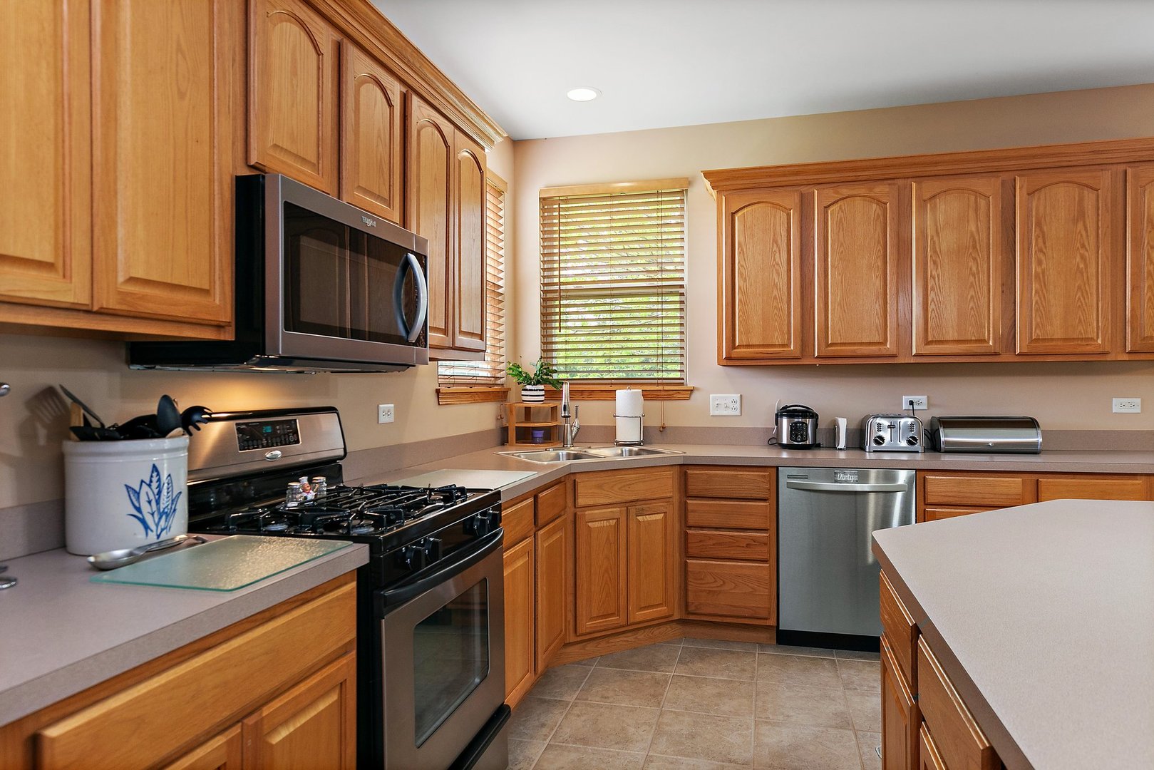 244 Prescott Avenue Elgin, IL 60124 - Photo 8 of 31 a kitchen with stainless steel appliances granite countertop a stove sink microwave and cabinets