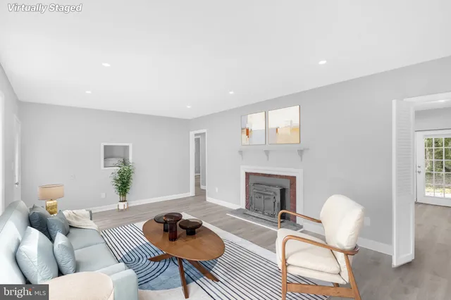 a living room with furniture a fireplace and a table