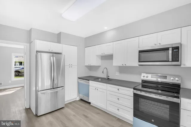 a kitchen with stainless steel appliances a refrigerator stove and microwave