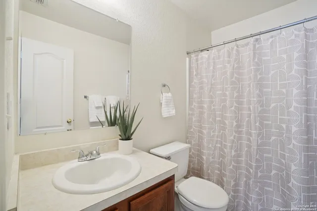 a bathroom with a sink toilet and mirror