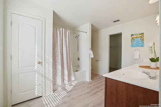 a view of a bathroom with a sink and a mirror