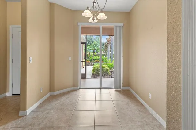 a view of a livingroom with a ceiling fan and kitchen view