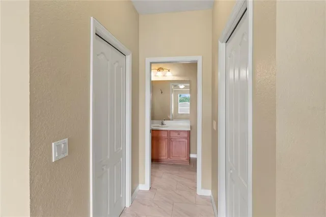 a view of a field with a big yard and palm trees