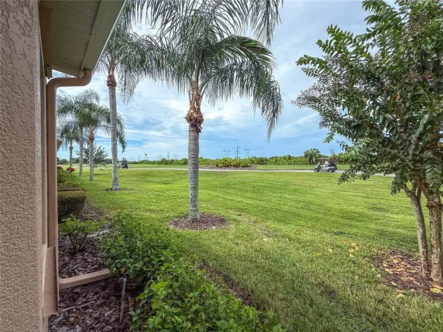 a potted plant sitting in front of a house with a yard