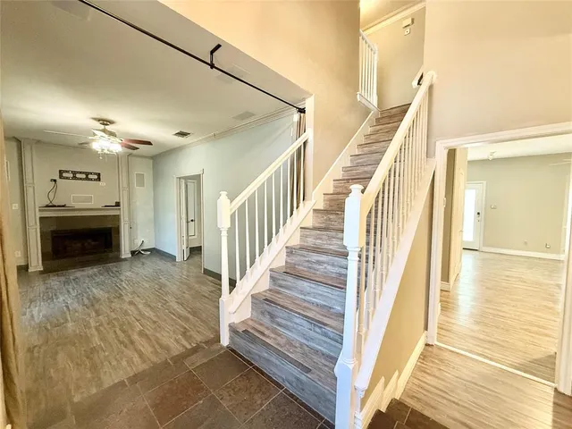 a view of a livingroom with wooden floor and a fireplace