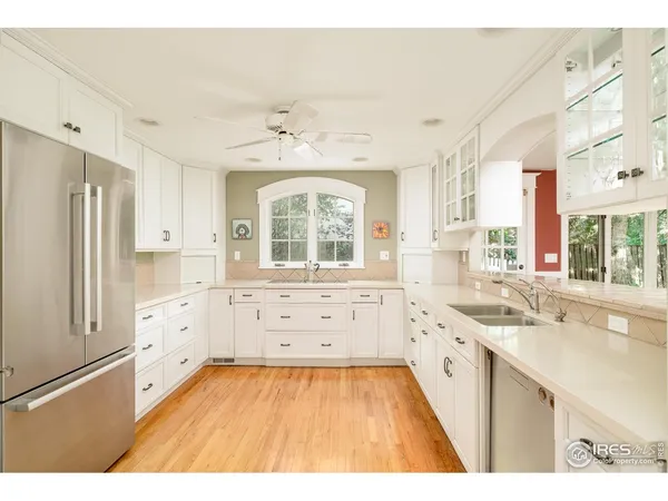 a large white kitchen with a window