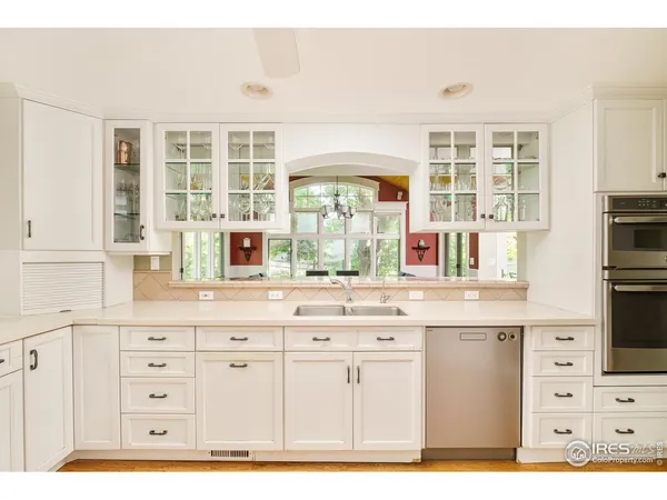 a kitchen with cabinets appliances and a window