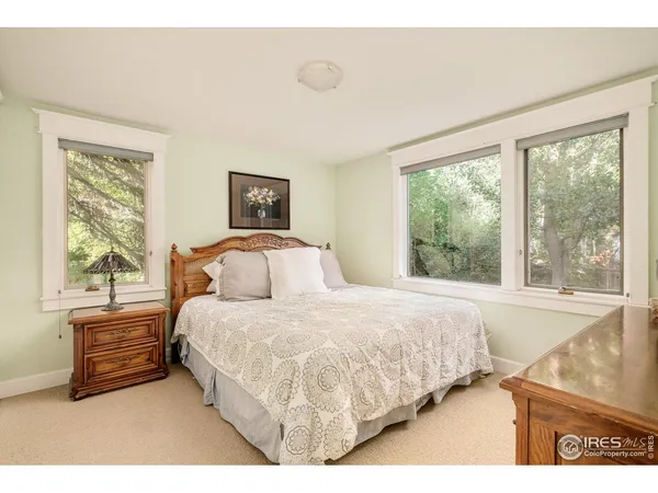 a bedroom with a bed next to a window