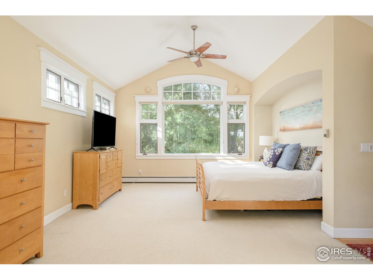 3788 26th Street Boulder, CO 80304 - Photo 23 of 47 a spacious bedroom with a bed and a flat screen tv