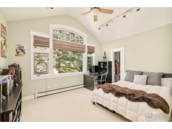 a bedroom with a large bed and a large window